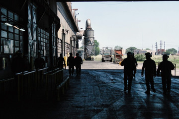 Silhouette of workers walking in a Factory