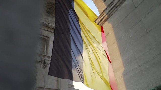 Belgium flag against tricolour stripes waving on wind from Arcade du Cinquantenaire 1920X1080 HD footage (1080p 100fps FullHD video)