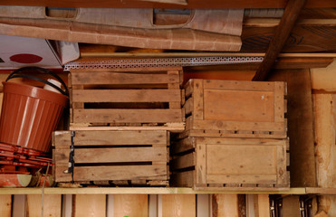 wooden boxes on a shelf in the barn.