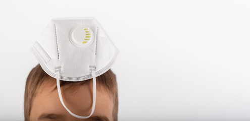Boy plays with protection mask, concept with copy space