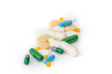 Heap of various medicine pills on white background.