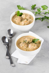Bean soup-puree with meatballs in a bowl on a light background