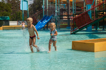 Naklejka premium children play in the water Park, pool, water, summer, vacation