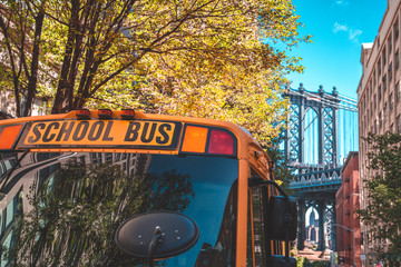 School bus in Brooklyn with a Manhattan bridge in the background.