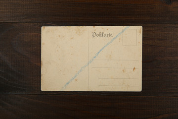 vintage postcard on wooden background. translation from German 