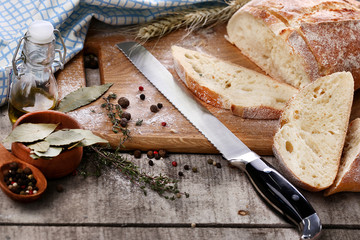Silver knife for bread with cutting bread on the desk