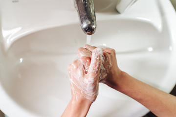 Man washing hands to protect against the coronavirus