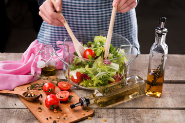 Peappararing  fresh salad by chief on the wooden table