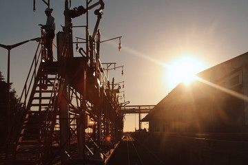 Silhouette of operator in oil train station