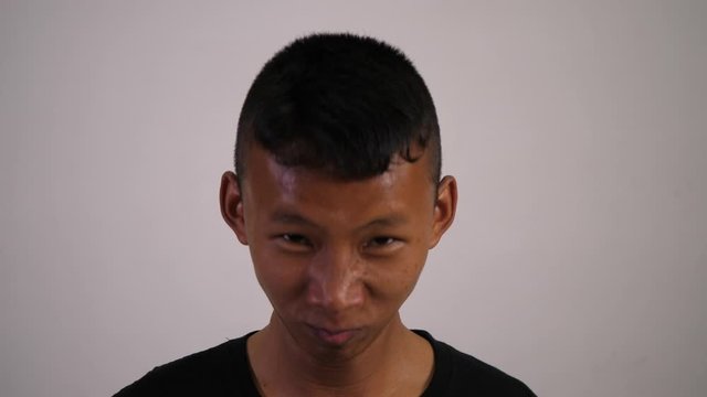 The face of a Asian teenager is a mad man and crazy.