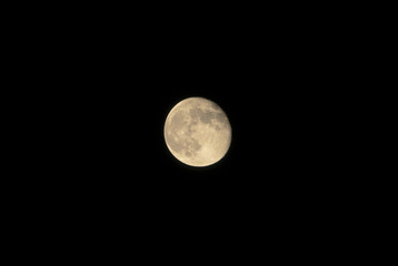 Full moon glowing on black background.