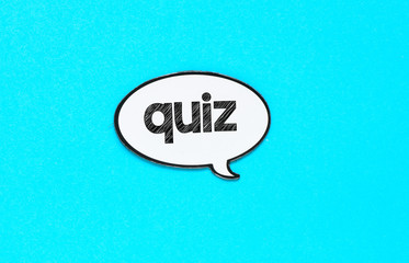 QUIZ with speech bubbles on blue background - concept.