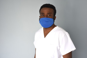 Doctor in mask. Black man african american doctor portrait wearing safety mask at work. Medical staff. Coronavirus.