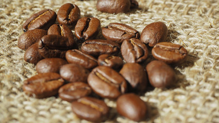 coffee beans lie on burlap in the sunlight