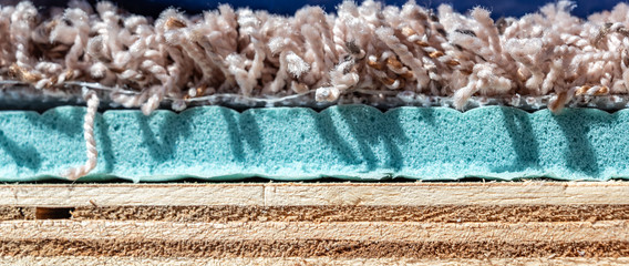 Carpet, padding, and plywood layers for installation of flooring