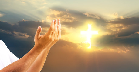 Religious young man praying outdoors