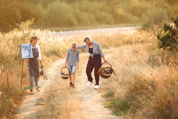 Two mothers with son. Family in a spring field.