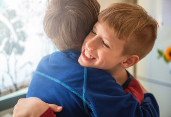 Smiling Brothers Hugging Each Other	
