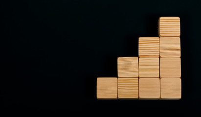 Wooden blocks folded in the shape of a triangle