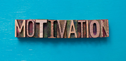 Motivation word written with wood type blocks
