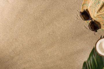 Fototapeta na wymiar Hat and sunglasses on sand background. Harsh light with shadows.