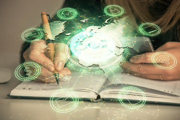 Double exposure of woman hands typing on computer and social network theme hologram drawing. People media concept.