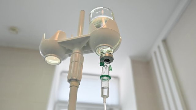 Glass bottle drip with saline iv therapy. Treatment in hospital
