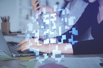 Multi exposure of woman hands working on computer and data theme hologram drawing. Tech concept.