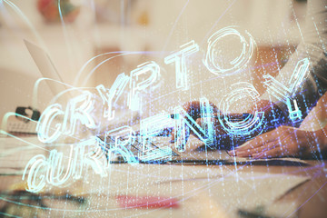 Double exposure of woman hands typing on computer and crypto market theme hologram drawing....