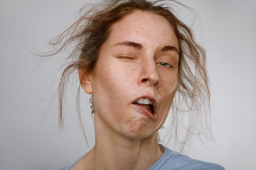 Headshot of young woman with brown messy hair. Sleepy concept. Close-up.