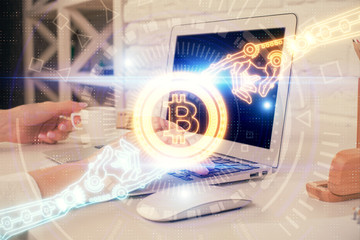Double exposure of woman hands typing on computer and crypto market theme hologram drawing....