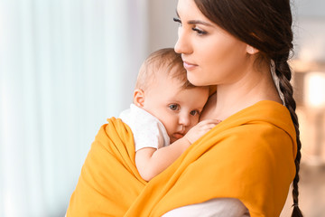 Happy mother with cute little baby at home