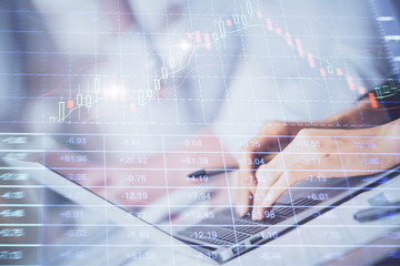 Double exposure of woman hands typing on computer and forex chart hologram drawing. Stock market invest concept.