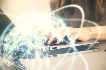 Double exposure of woman hands typing on computer and business theme hologram drawing. Success concept.
