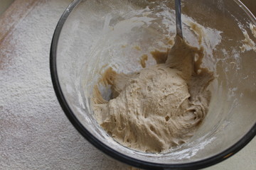 Rye Buckwheat dough rising in a bowl with a flour board dusted and used for baking