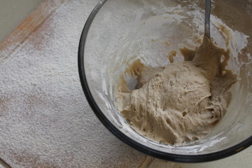 Rye Buckwheat dough rising in a bowl with a flour board dusted and used for baking