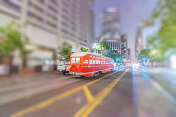 Plakat Red tram speeding up in Market Street at night, San Francisco.