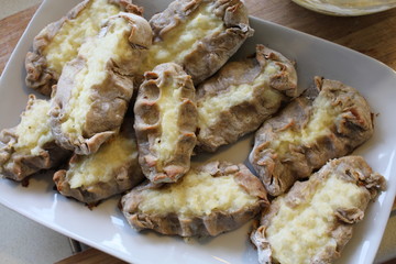 Cooked Karelian pies - Pirakka on a baking sheet. Dish of national cuisine - piirakka. Close-up.