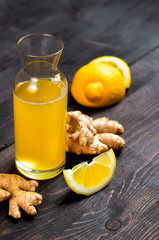 Ginger Ale - Homemade lemon and ginger organic probiotic drink or Kombucha. Ginger-lemon drink in a bottle, ingredients of ginger cocktail or tea: ginger root, lemon. copy space. selective focus