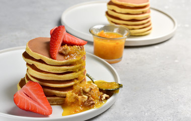 pancake with orange jam, nuts and fresh strawberries. Breakfast food in the morning. pancake recipe. selective focus and copy space. home cooking recipe