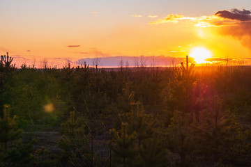 Sunset against the backdrop of large obese clouds.