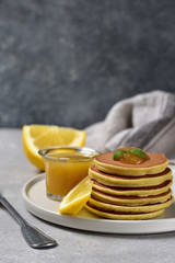 pancakes with lemon jam on a white craft plate. family Breakfast dish, food for children in the morning.  pancake recipe. food delivery gluten free pancakes