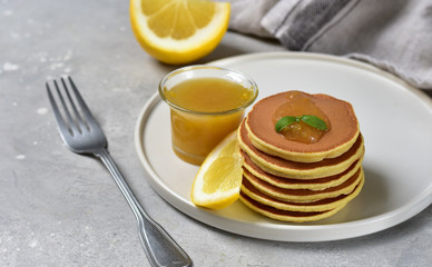 pancakes with lemon jam on a white craft plate. family Breakfast dish, food for children in the morning.  pancake recipe. food delivery gluten free pancakes
