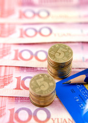 Coins with card on Chinese currency
