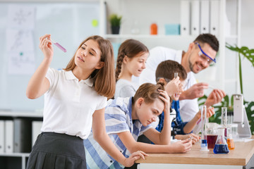 Pupils at chemistry lesson in classroom