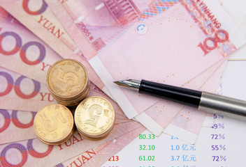 Money,pen and financial charts