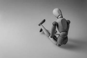 human figurine depicting a lonely bored person, the concept of abandonment and uselessness, despair...