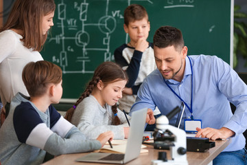 Teacher conducting physics lesson in classroom