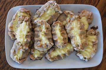 Cooked Karelian pies - Pirakka on a baking sheet. Dish of national cuisine - piirakka. Close-up.