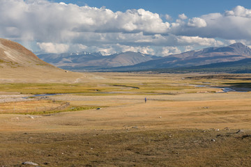 Man riding a motorbike in the steppes of Mongolia, on the hills of Mongolia
